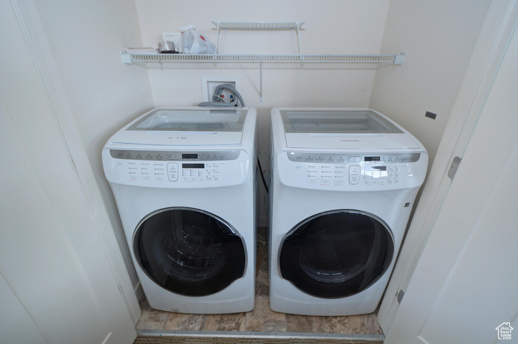 Laundry room with washer hookup, washer and dryer, and tile flooring