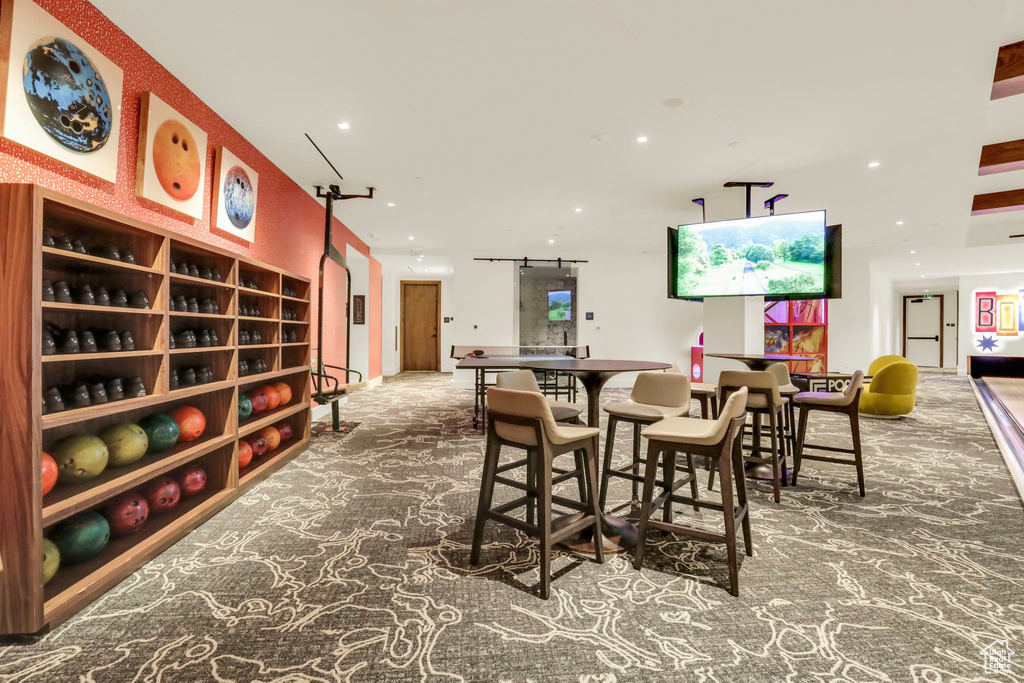 Carpeted dining room with a bowling alley