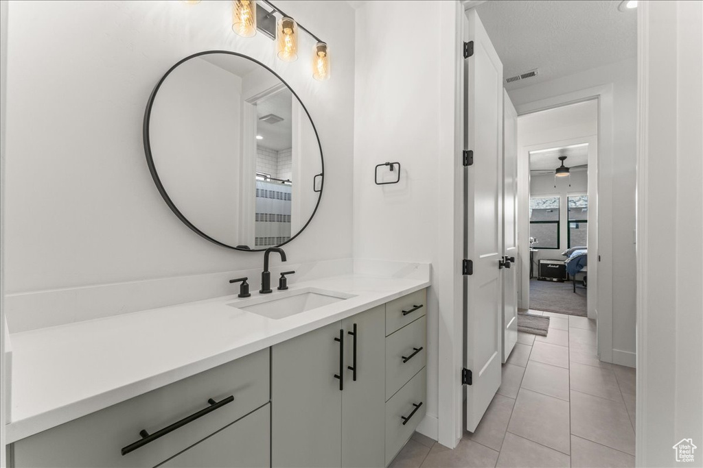 Bathroom with vanity, tile flooring, and ceiling fan