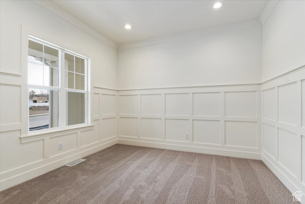 Empty room with light carpet and ornamental molding