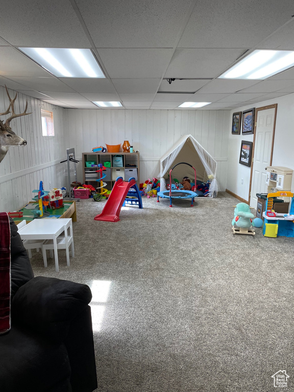 Playroom featuring carpet flooring and a paneled ceiling