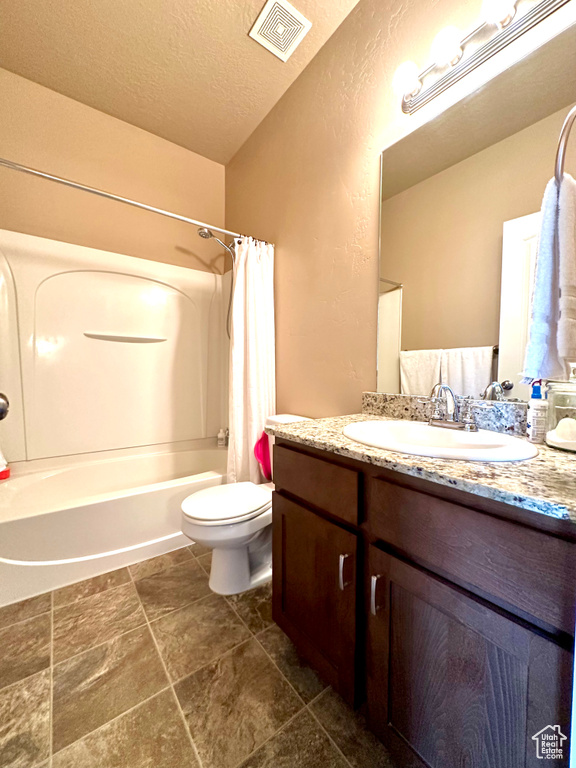 Full bathroom with shower / bathtub combination with curtain, toilet, tile flooring, and large vanity