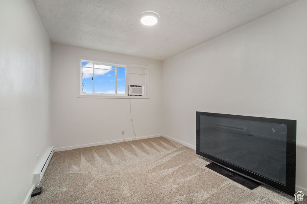 Carpeted empty room with baseboard heating