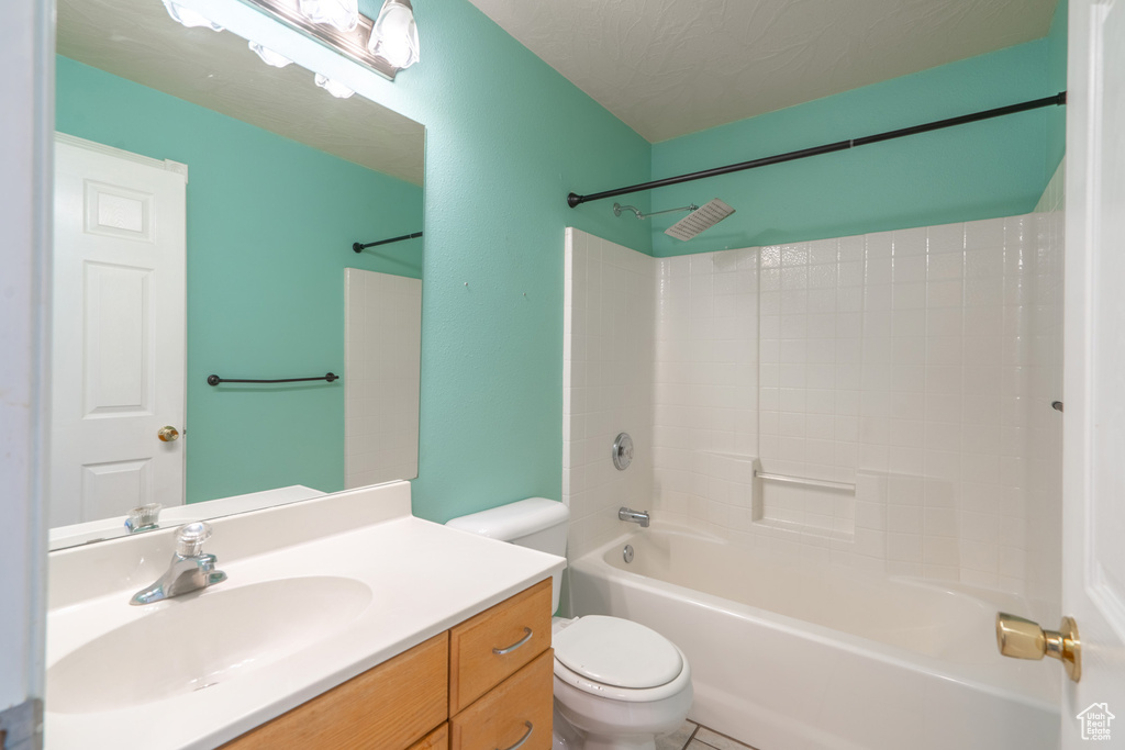 Full bathroom featuring tub / shower combination, tile floors, toilet, and vanity