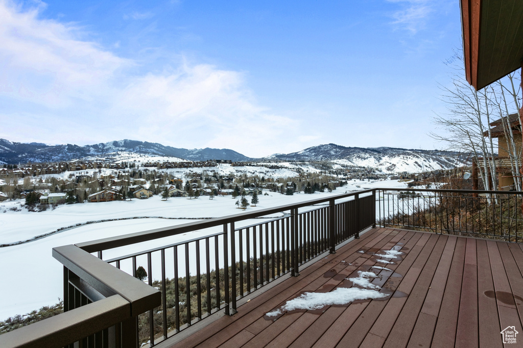Snow covered deck with a mountain view