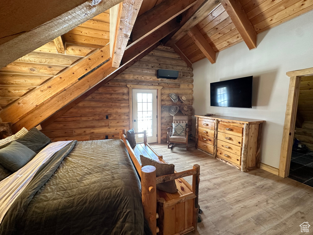 Bedroom with lofted ceiling with beams, wood ceiling, and hardwood / wood-style floors