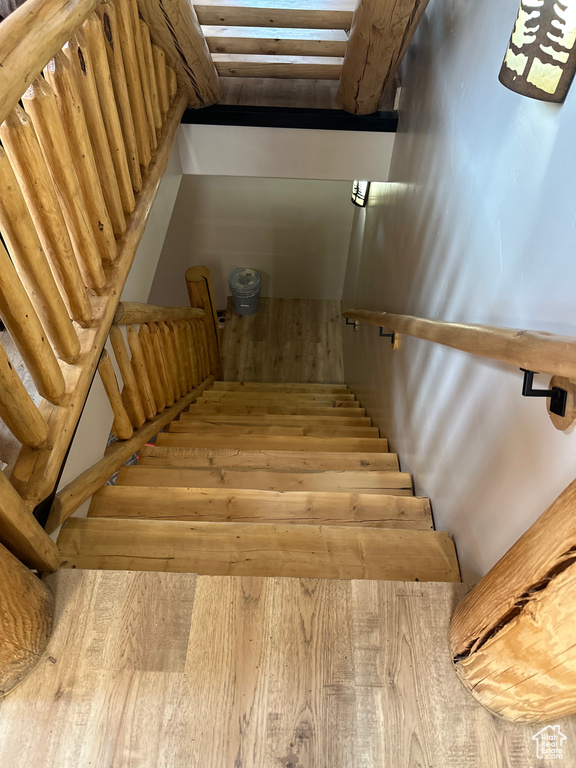 Staircase featuring light wood-type flooring