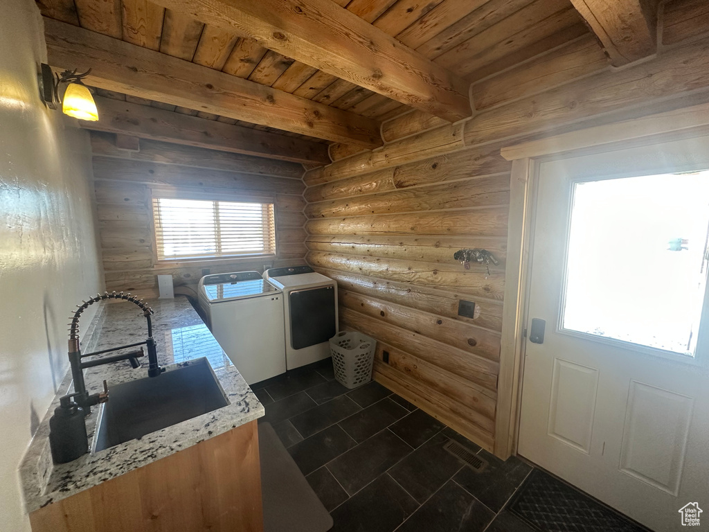 Kitchen featuring sink, beam ceiling, wood ceiling, plenty of natural light, and independent washer and dryer