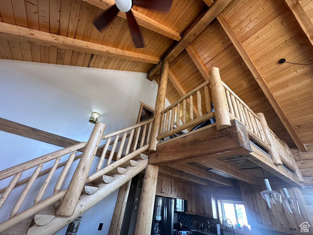 Stairs featuring high vaulted ceiling, wood ceiling, beamed ceiling, and ceiling fan