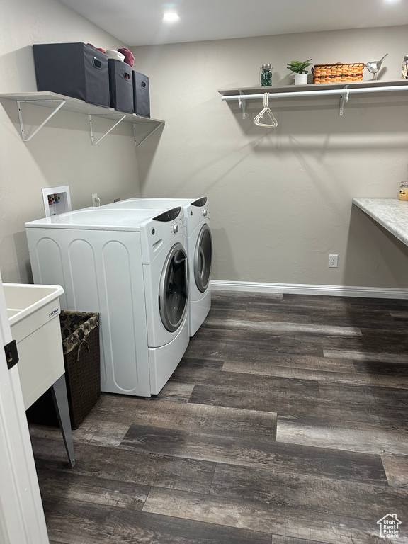 Laundry room featuring hookup for a washing machine, washer and clothes dryer, and dark wood-type flooring