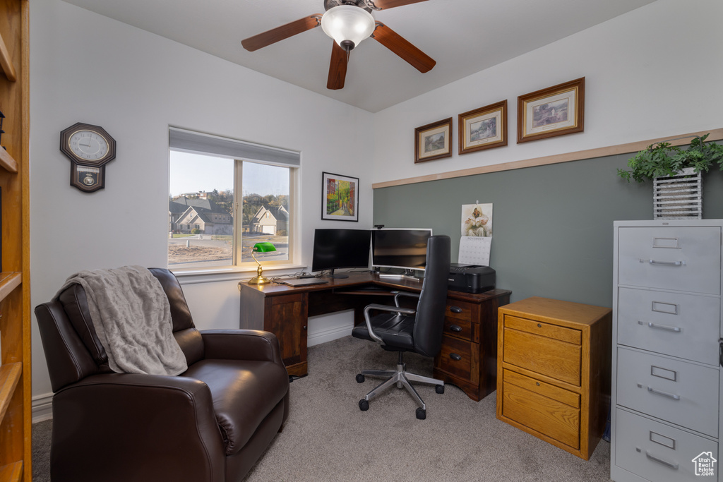 Office space with light carpet and ceiling fan