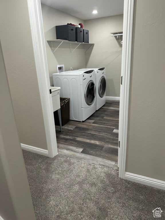 Laundry room featuring hookup for a washing machine, dark wood-type flooring, and separate washer and dryer