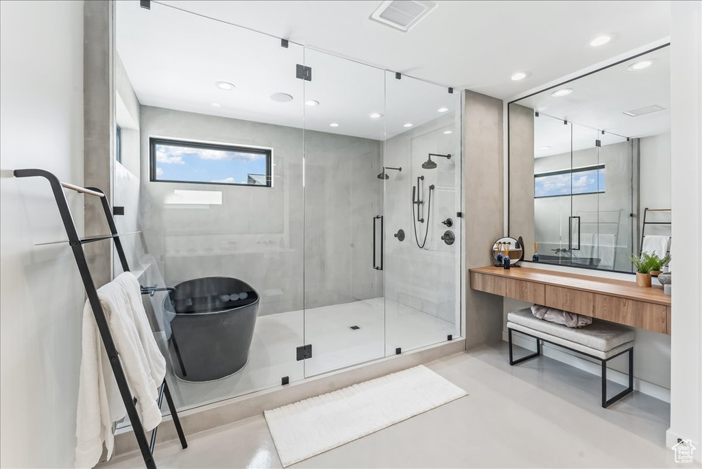 Bathroom with vanity and a shower with door
