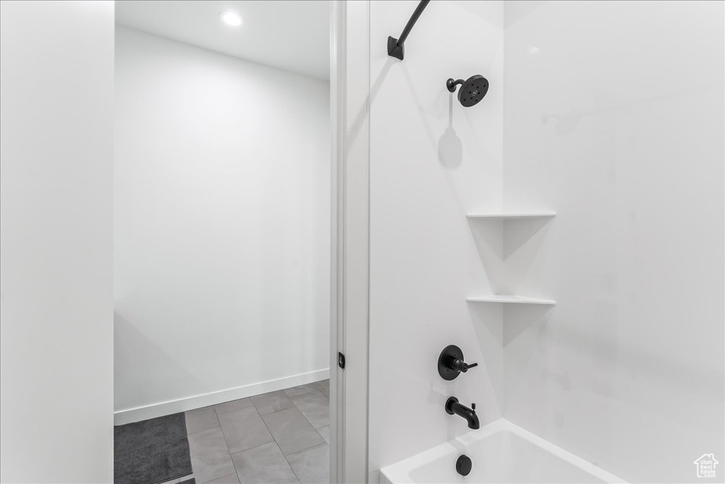 Bathroom featuring shower / bathtub combination and tile floors