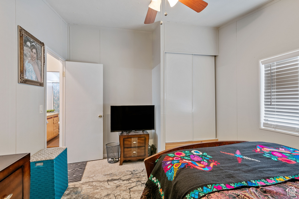 Bedroom with connected bathroom and ceiling fan