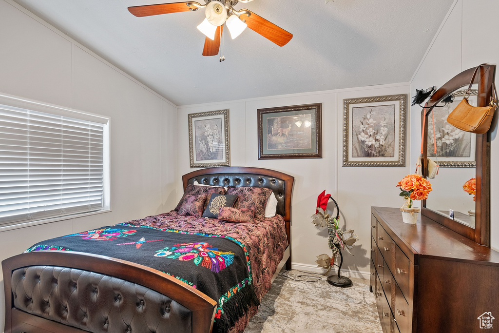 Bedroom featuring ornamental molding, lofted ceiling, and ceiling fan