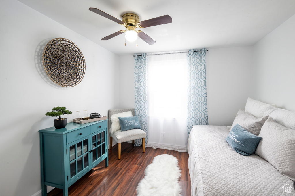 Bedroom with ceiling fan and dark hardwood / wood-style floors