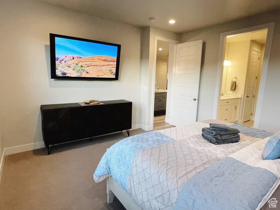 Bedroom featuring carpet and connected bathroom