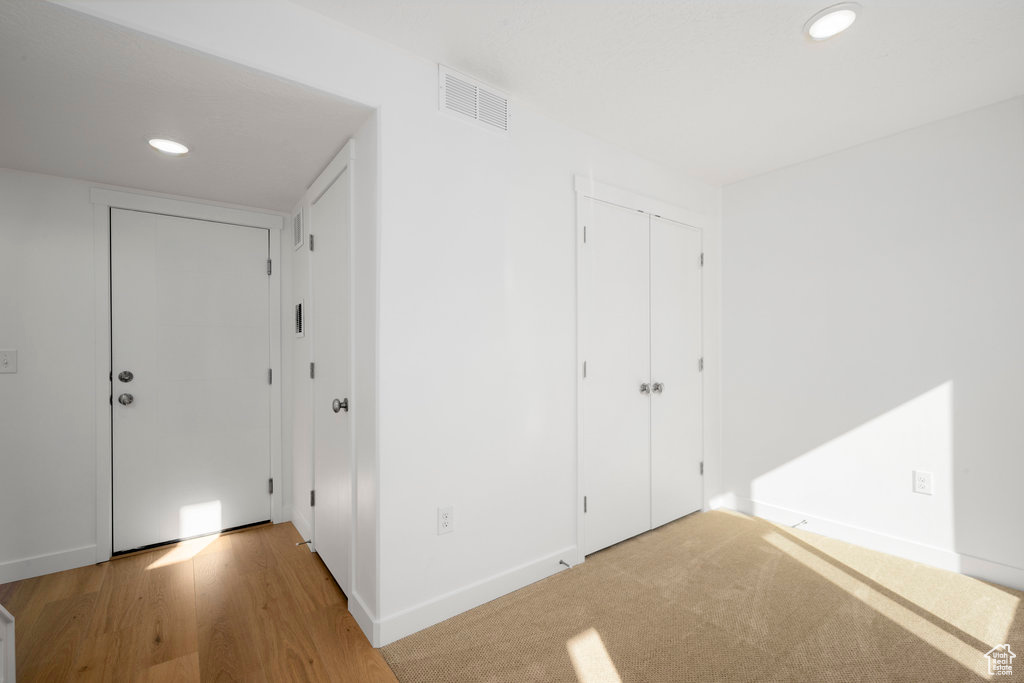 Interior space with a closet and light colored carpet