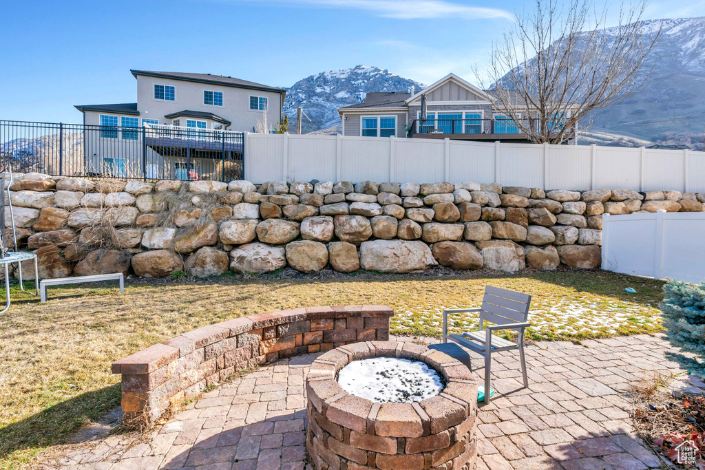 View of patio featuring a mountain view and a fire pit