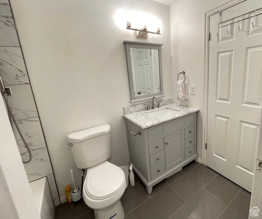 Full bathroom featuring vanity, tile flooring, bathing tub / shower combination, and toilet