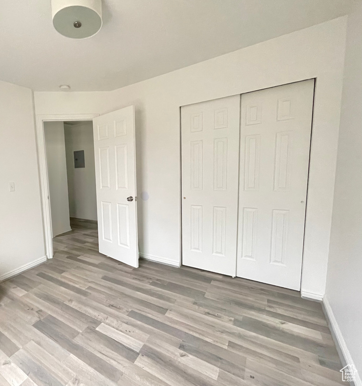 Unfurnished bedroom featuring a closet and light hardwood / wood-style flooring
