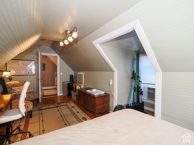 Bedroom with wood-type flooring, vaulted ceiling, and wood ceiling
