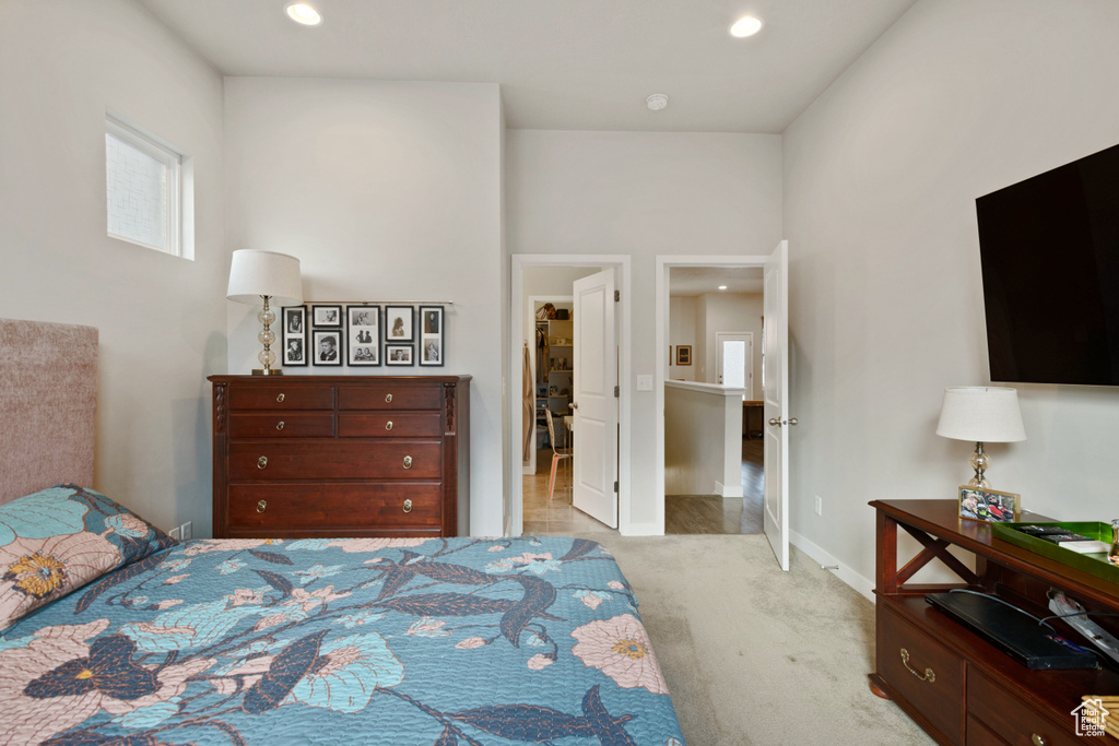 Carpeted bedroom with a walk in closet