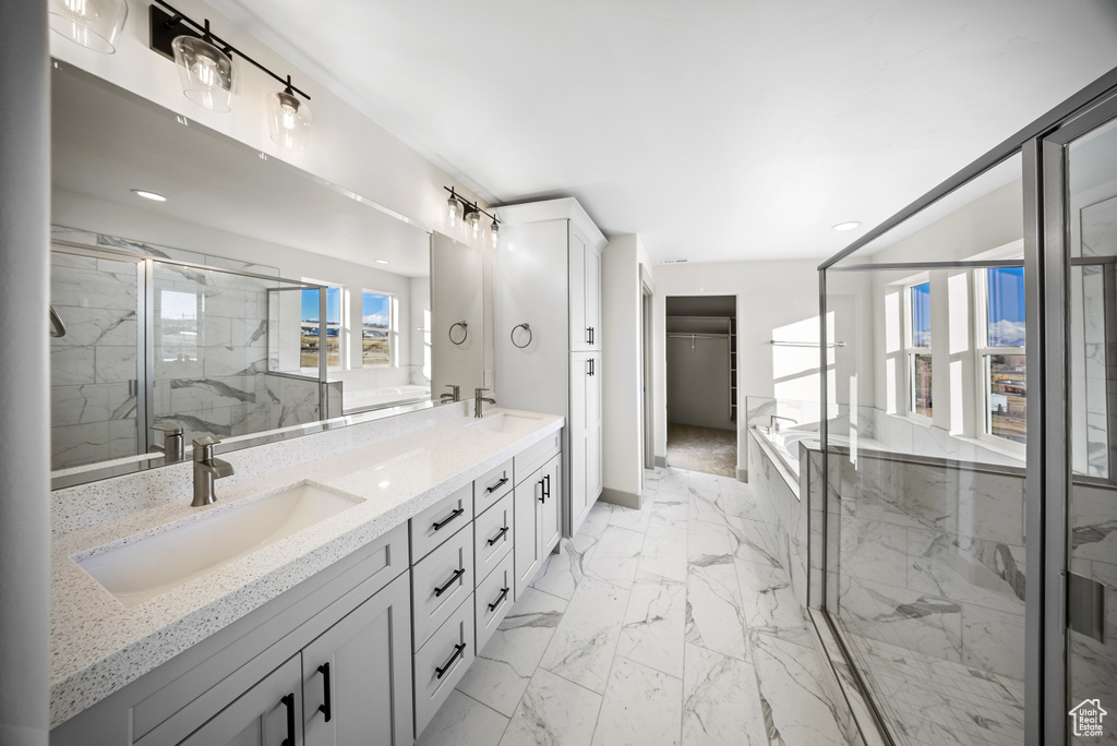 Bathroom with an enclosed shower, dual sinks, tile flooring, and large vanity