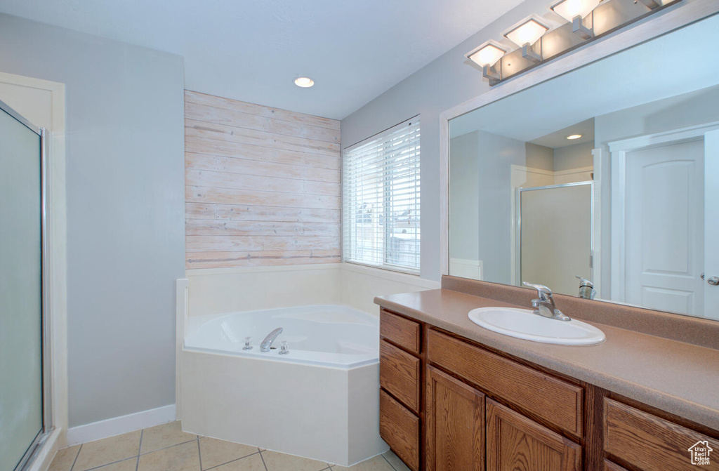 Bathroom with shower with separate bathtub, oversized vanity, and tile floors