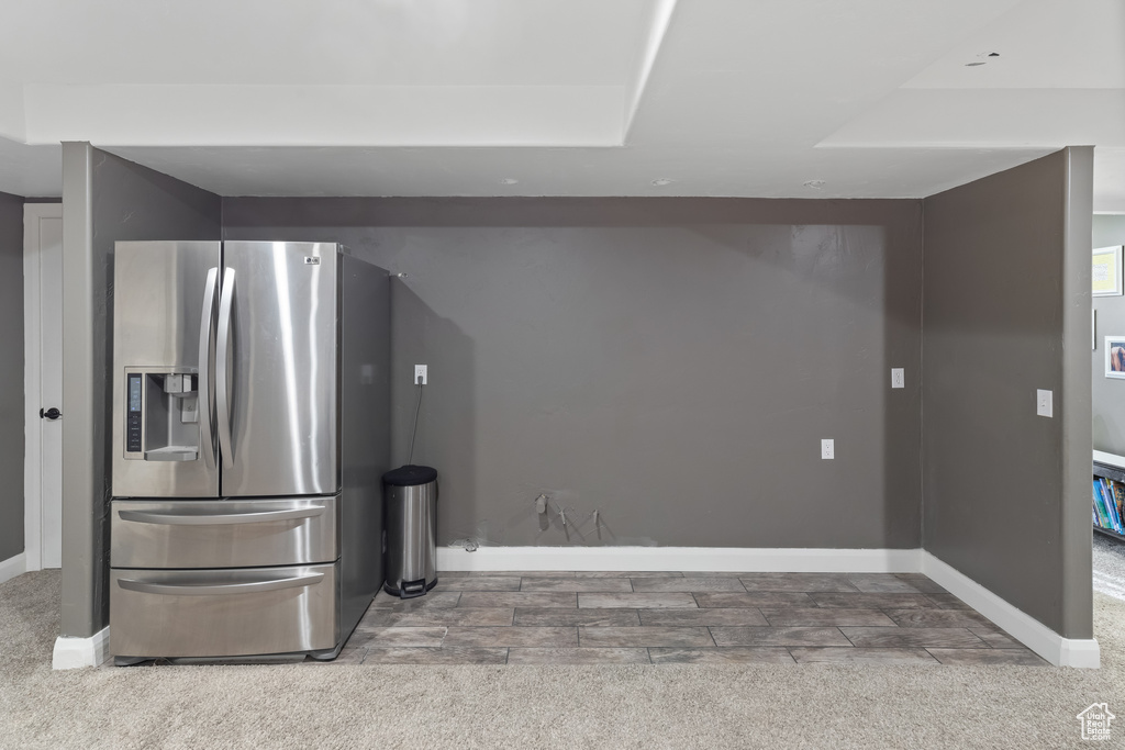 Kitchen with carpet and stainless steel fridge with ice dispenser