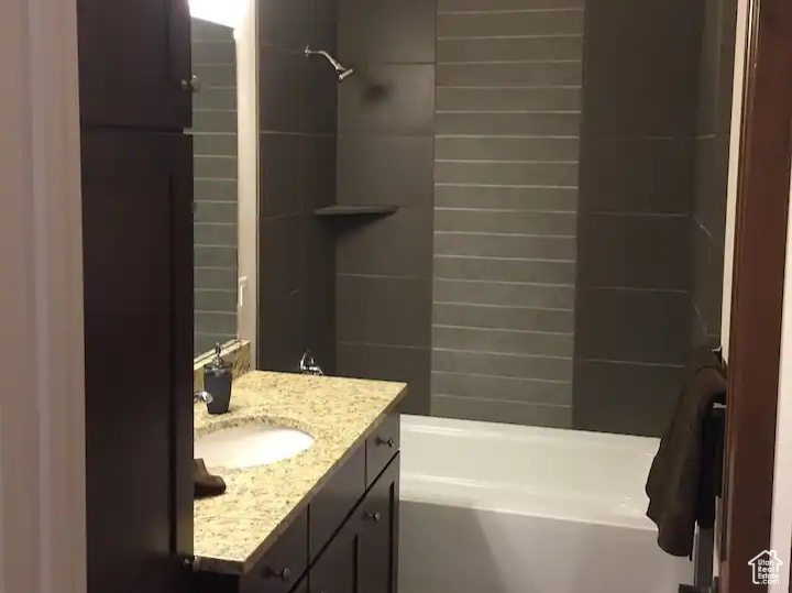 Bathroom featuring vanity and  shower combination