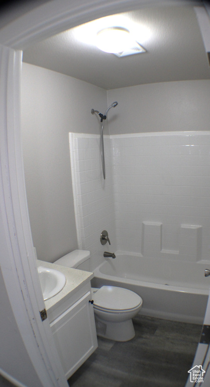 Full bathroom featuring shower / bathtub combination, hardwood / wood-style flooring, toilet, and vanity