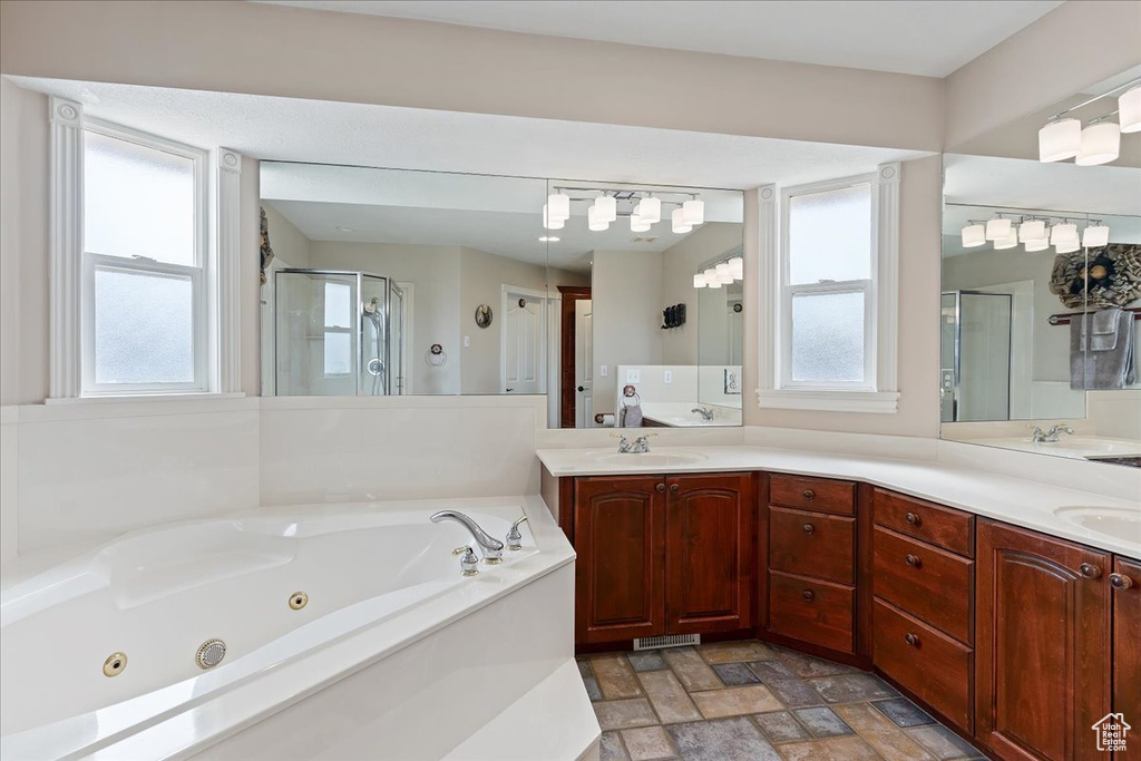 Bathroom with double sink, a healthy amount of sunlight, tile flooring, and large vanity
