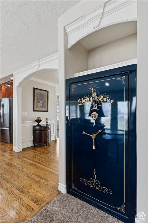 Interior details with stainless steel refrigerator and dark hardwood / wood-style floors