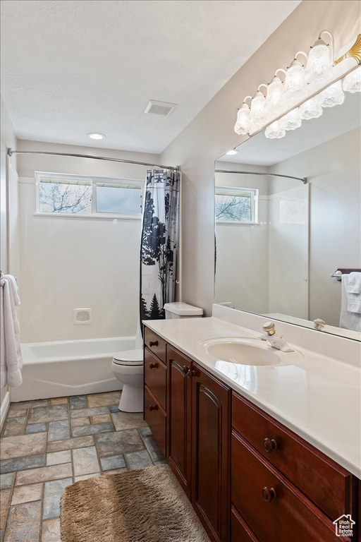 Full bathroom featuring tile flooring, shower / bath combo, toilet, and vanity