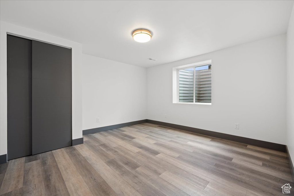 Empty room with hardwood / wood-style floors