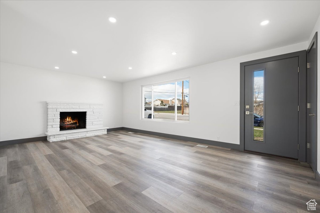 Unfurnished living room featuring dark hardwood / wood-style flooring and a fireplace