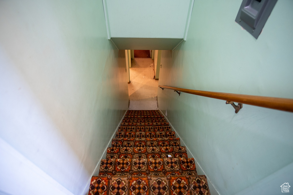 Stairway with dark tile flooring