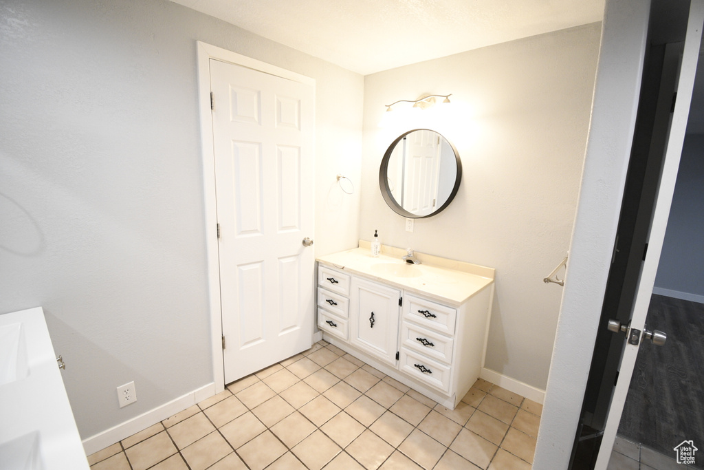 Bathroom with tile flooring and large vanity