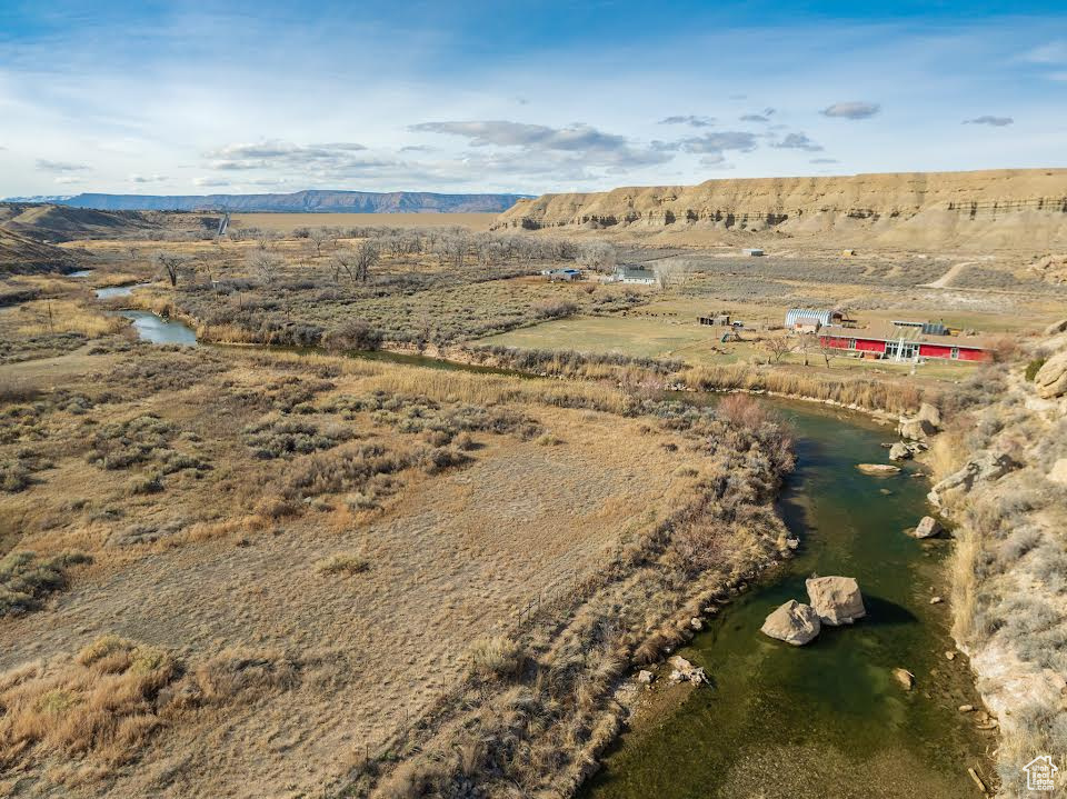 Birds eye view of property featuring a water and mountain view