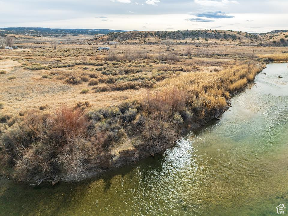 Birds eye view of property with a water view