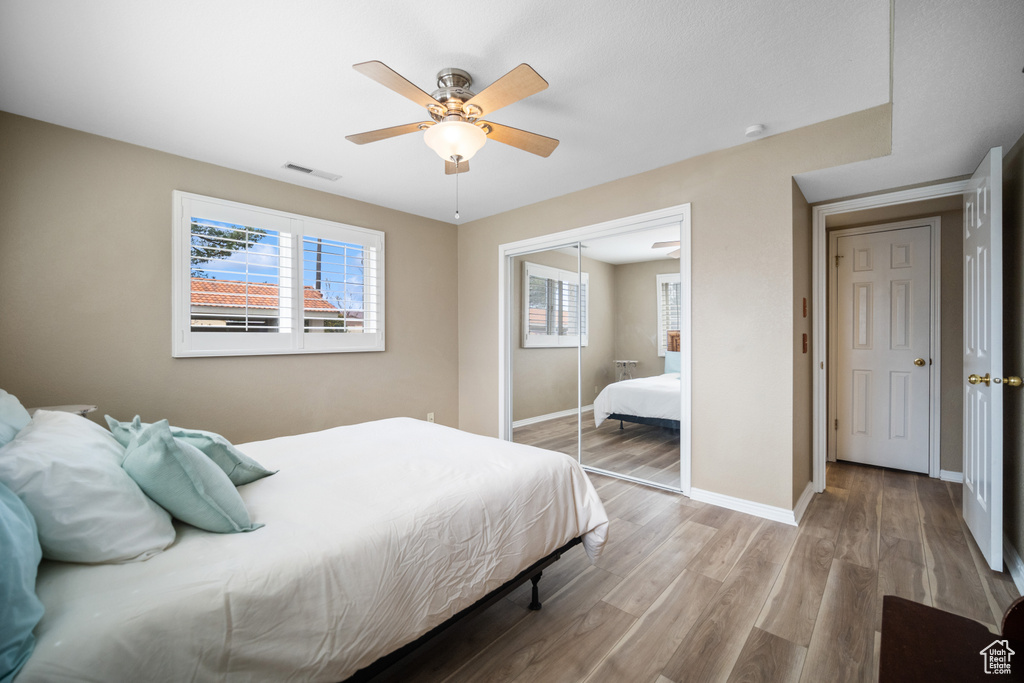 Bedroom featuring a closet, light hardwood / wood-style floors, and ceiling fan