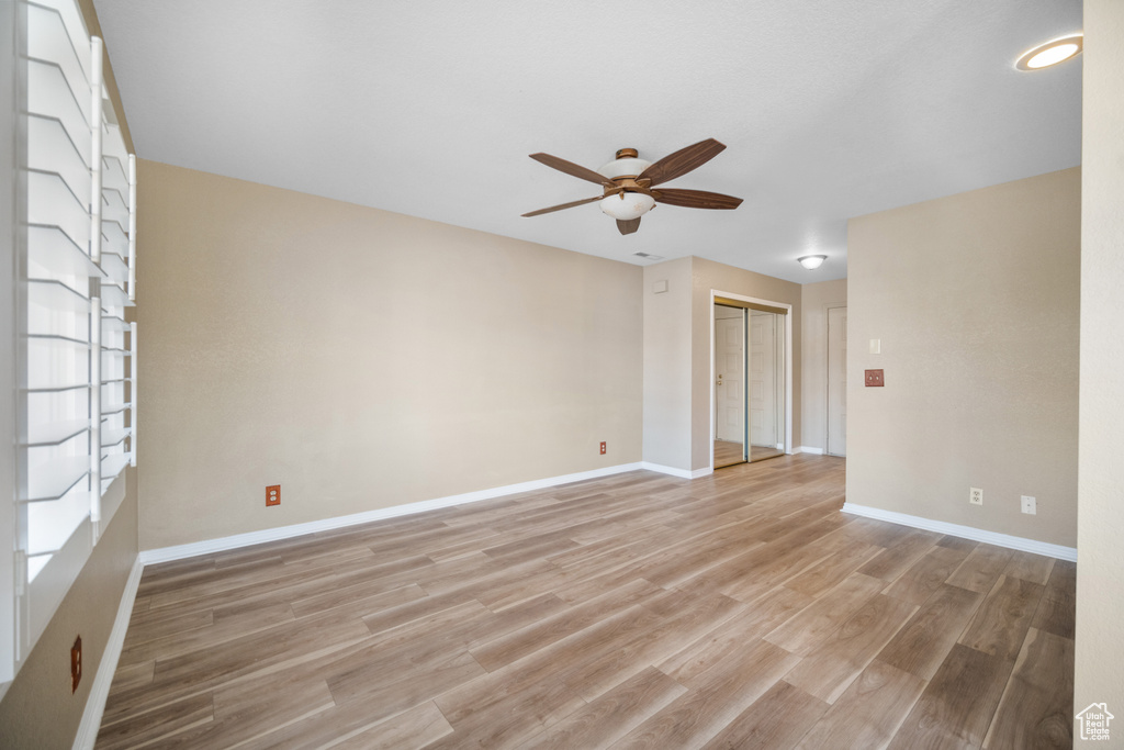Spare room with ceiling fan and light hardwood / wood-style floors