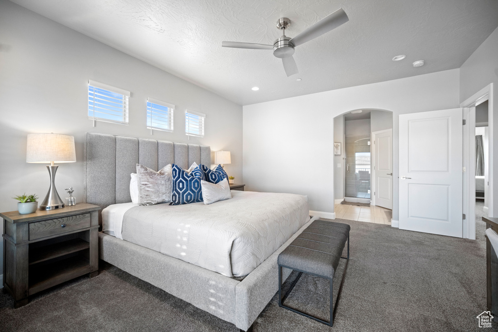 Bedroom featuring carpet floors, connected bathroom, and ceiling fan