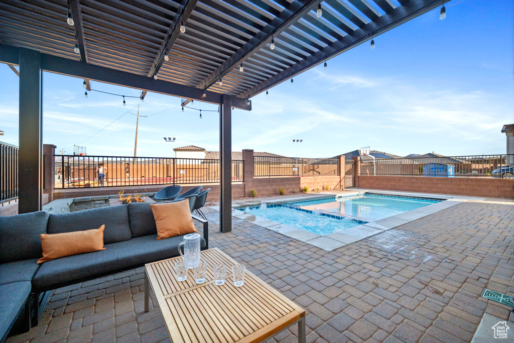 View of swimming pool with a patio area, an outdoor hot tub, and a pergola