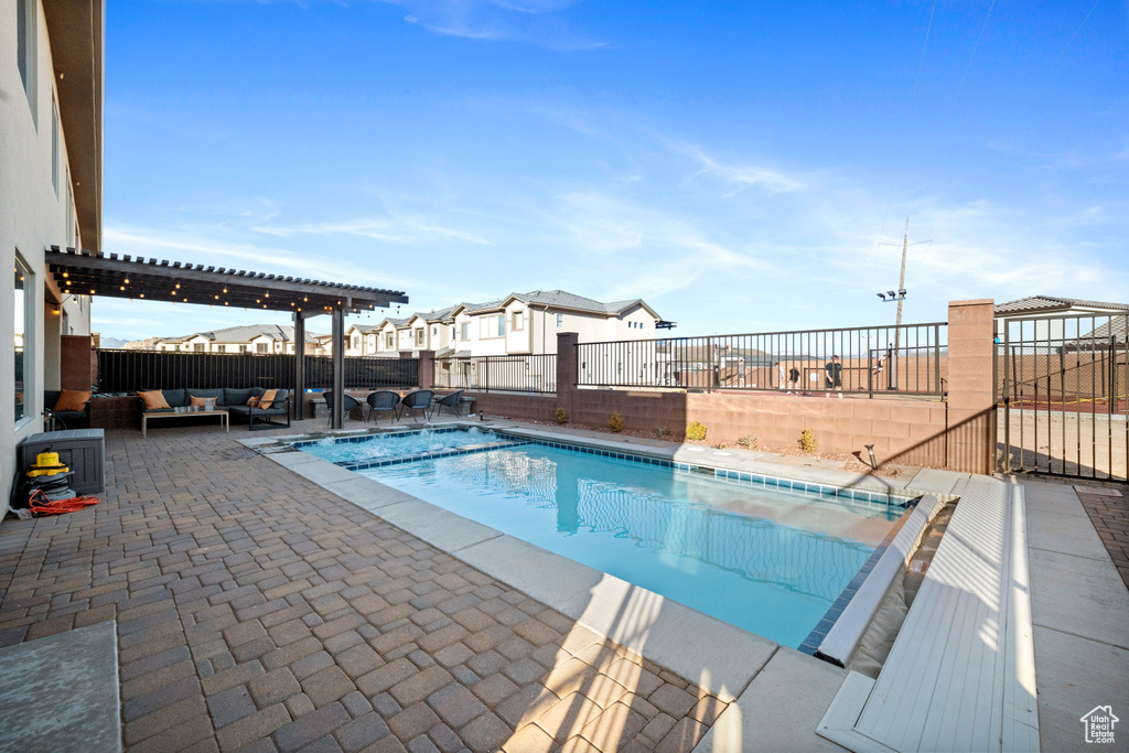 View of swimming pool with a patio, an outdoor living space, and a pergola