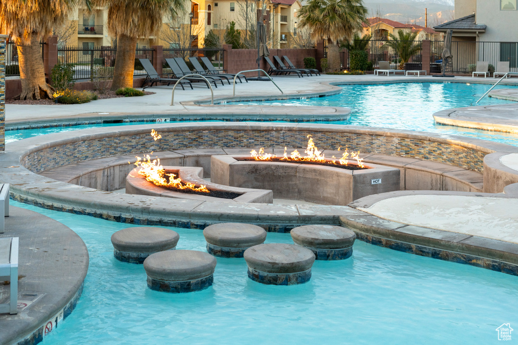 View of swimming pool featuring an outdoor fire pit