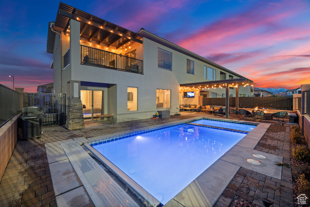 Pool at dusk with a patio