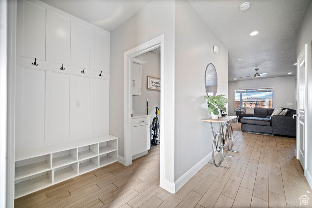 Mudroom featuring light hardwood / wood-style flooring and ceiling fan